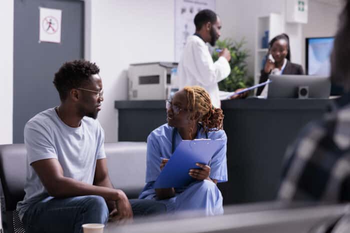 Medical assistant examining young man