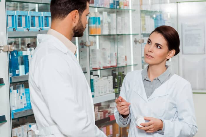 pharmacist with jars of pills